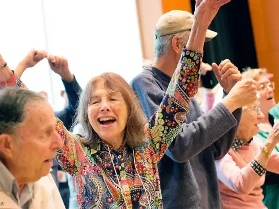 giving voice chorus woman with arms raised in joy