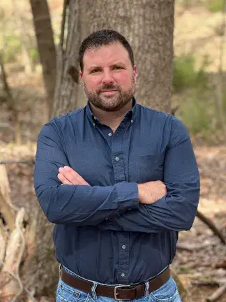 Shawn Crouch with arms crossed looking at camera