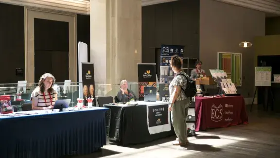a woman walking through the exhibit hall