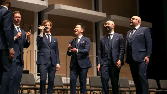 6 member all men chorus two holding maracas