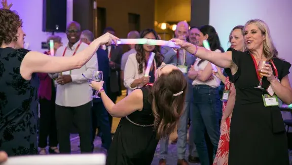 three people playing limbo on the dance floor