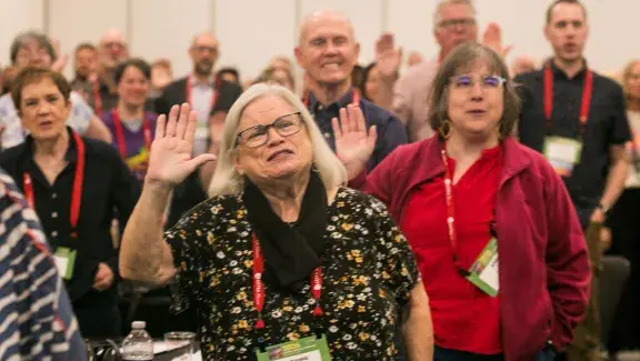 attendees holding hand up and saying advocacy oath